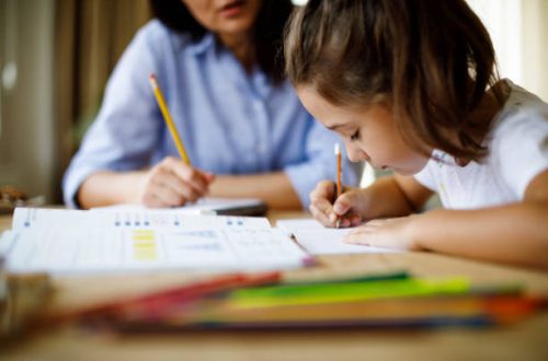 Mother helping daughter with homework
